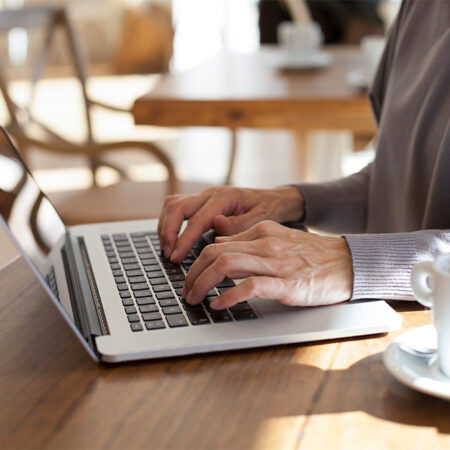 Person with laptop and coffee