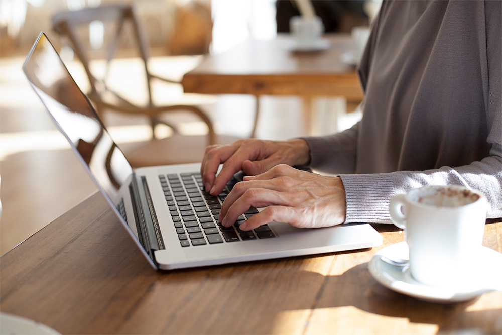 Person with laptop and coffee